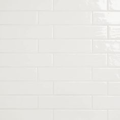 a white tiled wall with black grouting