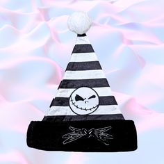 a black and white striped hat with a jack o lantern on it