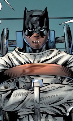 a batman sitting in a chair with his hands on the belt