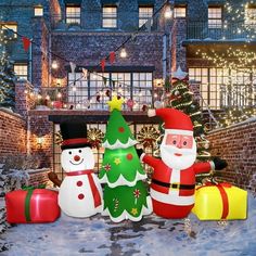 three inflatable christmas decorations sitting next to each other on the snow covered ground