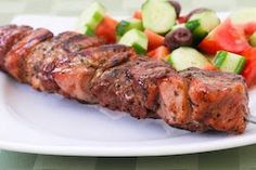 a close up of a plate of food with meat and veggies on it