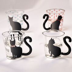 four glass mugs with black cats on them