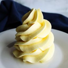 a white plate topped with sliced apples on top of a blue cloth covered tablecloth