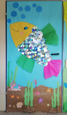 a door decorated to look like a fish and under the sea with lots of bubbles