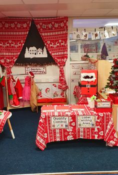 a room decorated for christmas with red and white decorations on the walls, windows, and desks