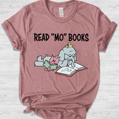 It's A Good Day To Read Book - Teacher Library Book Club Kindergarten School Tshirt, Back To School Pre-K Piggie Gerald Pigeon C-02022324 Please consider carefully about our description before taking an order. ∘◦ ☆ ◦∘ HOW TO ORDER? ∘◦ ☆ ◦∘ Placing an order is simple! Please review all images in this listing for style, color and sizes. - Select the size and color of the shirt from the drop-down menus. - Add your design color on the empty box for personalization (Example: Design Color: White). - S Piggie And Elephant, Teacher Library, Teacher Book, Books Shirt, It's A Good Day, School Tees, Book Tshirts, Fantasy Novel, Book Shirts