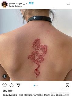 a woman with a dragon tattoo on her back