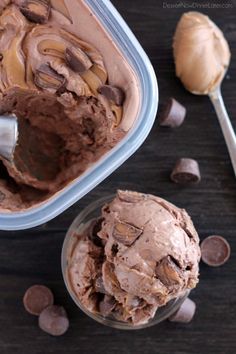 chocolate ice cream in a plastic container with spoon next to it