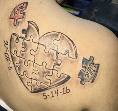 a man with a tattoo on his back has a puzzle piece in the shape of a heart