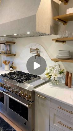 a stove top oven sitting inside of a kitchen next to a wall mounted oven hood