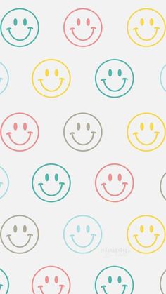 many different colored smiley faces on a white background