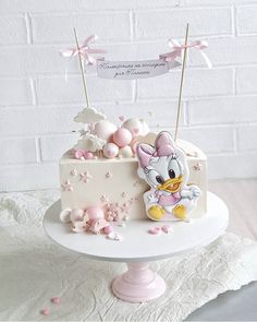 a cake decorated with pink and white decorations