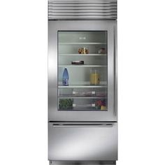 a stainless steel refrigerator with its door open and shelves full of food on the bottom shelf