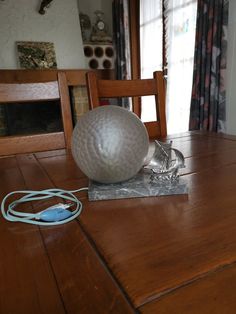 a table that has a ball on top of it and a charger plugged in