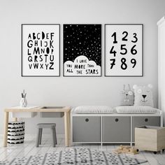 three black and white posters hanging on the wall above a child's bed in a children's room