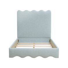 a white bed frame with scalloped headboard and foot board