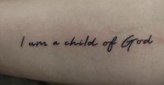 a tattoo saying i am a child of god on someone's left arm,