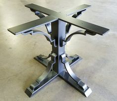 a metal table that is on top of a cement floor with no one around it