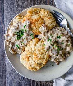 biscuits and gravy on a plate with a fork