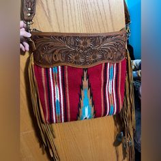 Life's Too Short To Not Make A Statement With This Gorgeous Arizona Saddle Blanket Crossbody Handcrafted From Genuine Leather. You'll Be Turning Heads With The Beautiful Natural Colors That Pop Against The Textured Tooled Leather Design. Rock It Like A Boss Lady And Show The World Your Style - Because You're Worth It!! Dimensions: 15in X 15in Used Maybe Twice! In Excellent Condition! You're Worth It, Life's Too Short, Saddle Blanket, Tooled Leather, Like A Boss, Natural Colors, Too Short, Leather Tooling, Leather Design