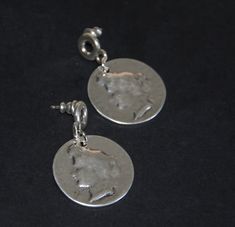 A pair of earrings made by silver plated Zamak. Carved coin model drop pieced earrings. Anti-allergic high quality earrings. Size: 27mm 1.1 inches, diameter of the pendant. Net weight:13g Vintage Nickel-free Earrings For Festival, Nickel-free Silver Round Plug Earrings, Vintage Silver Coin Earrings, Vintage Silver Screw Back Earrings, Vintage Tarnish-resistant Coin-shaped Jewelry, Leather Cord Bracelets, Hanging Earrings, Earrings Vintage, Photo Bracelet