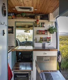 the interior of a small camper with open shelves