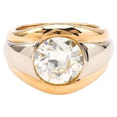 a gold and silver ring with a diamond