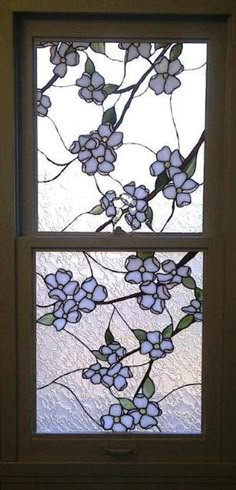 a stained glass window with white flowers on it