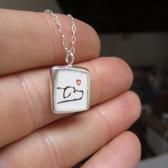 "You love your cat and your dog! This necklace has a stick kitty on one side and a lab on the other, both in black and white. Handmade with sterling silver and enamel this measures about 3/4 of an inch tall and hangs from a sterling silver chain with a spring ring clasp. Each piece is cast in sterling silver, to which 3 layers of vitreous enamel are applied and fired. Finally, I apply and fire the custom screen prints made from my drawings. Adorable, durable, and unique! Look for the matching ea Sterling Silver White Necklace For Best Friend Gift, White Sterling Silver Necklace For Best Friend Gift, Sterling Silver White Jewelry For Best Friend Gift, Hand Stamped White Sterling Silver Necklaces, Hand Stamped Sterling Silver White Necklace, White Sterling Silver Hand Stamped Necklace, Vitreous Enamel, Custom Screen Printing, Dog Jewelry