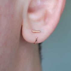 My classic staple ear huggers that you love got a much needed update: with a thicker 1.3mm round front staple part, they look so good!  Obviously, you can still get the classic ones with a 1mm front staple part here: https://www.etsy.com/ca/listing/885665944/solid-14k-yellow-gold-bar-ear-hugger?click_key=85e01a58068f68fd5f5d5b773af19185f7fa8e40%3A885665944&click_sum=c422ed88&ref=shop_home_active_3&pro=1&frs=1&sts=1 but if you're looking for something that will definitely stand out more, these ar Minimalist 14k Gold Huggie Ear Climbers, Minimalist 14k Rose Gold Ear Climbers, Minimalist Rose Gold Huggie Cartilage Earrings, Minimalist Rose Gold Ear Climbers For Everyday, Everyday Minimalist Rose Gold Ear Climbers, Minimalist Huggie Ear Climbers With Ear Wire, Minimalist Hypoallergenic Rose Gold Ear Climbers, Minimalist Rose Gold Huggie Earrings, Staple Earrings