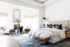 a bedroom with a large bed and white walls