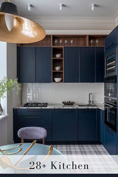 a kitchen with blue cabinets and an island table in front of the stove top oven