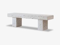 a concrete bench sitting on top of a white floor