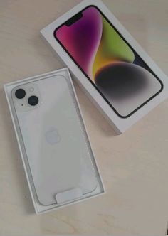 an apple iphone 11 in its box next to it's packaging on a table