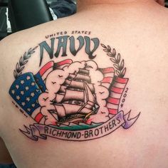 the back of a man's shoulder with an american flag and a ship on it