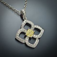 The soft design of this flower-shaped pendant features .38 carats of G VS2 round brilliant white diamonds and a .52 carat GIA-certified cusion-cut yellow diamond. The pendant is set in 18K white gold and delicately floats on a 16 inch 18K white gold cable chain. Luxury Yellow Diamond Necklace With Accents, Yellow Diamond Fine Jewelry Necklace, Yellow Diamond Necklace In Fine Jewelry Style, Fine Jewelry Yellow Diamond Necklace, Yellow Diamond Jewelry With Single Cut Diamonds, Luxury Yellow Flower Shaped Jewelry, Luxury Yellow Flower-shaped Jewelry, Jewellery Expensive, Amazing Necklaces