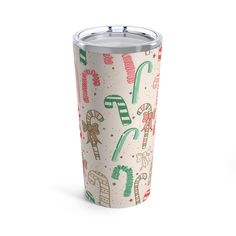 a christmas themed tumbler cup with candy canes and candies on the side