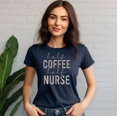 a woman wearing a t - shirt that says coffee and nurse on the front, standing in front of a white brick wall