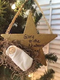 a christmas tree ornament with a baby's boot and blanket hanging from it