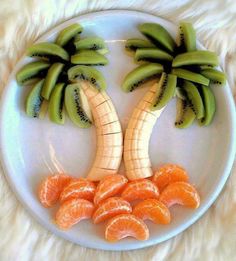 a white plate topped with sliced oranges and banana's on top of each other