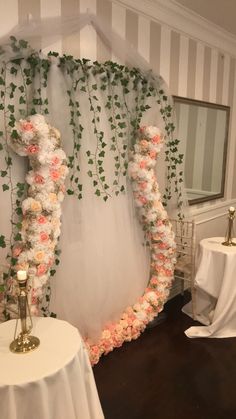 a wedding arch decorated with flowers and greenery for the bride's entrance to the reception room