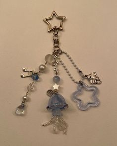 a key chain with various charms hanging from it's sides on a white surface