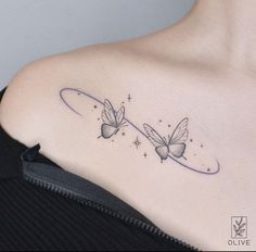 a woman's shoulder with two butterflies on it and the word love written in cursive writing