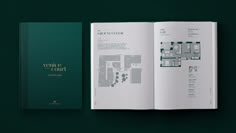 a book opened to show the floor plan for a building with green walls and gold lettering