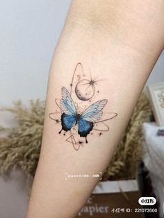 a blue butterfly tattoo on the arm