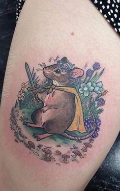 a tattoo with a mouse holding a knife in it's hand and flowers around it