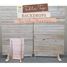 the back drop is made out of wood and has a sign that says, table top backgrounds for any occasion