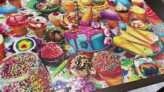 a table covered in lots of different colored candies