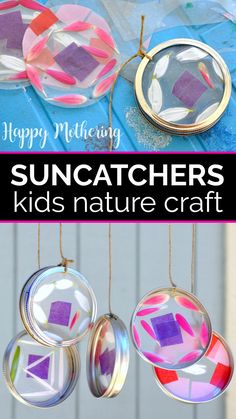 suncatchers made out of glass and paper are hanging from strings on a blue table