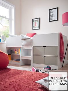 a white bunk bed sitting in a bedroom next to a red rug